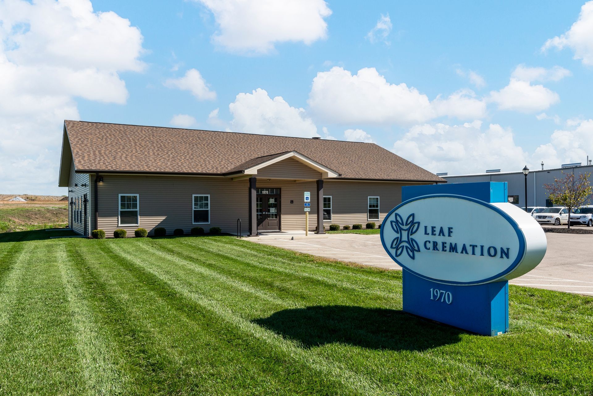 A hallway in a building with a lot of glass doors and a rug on the floor.