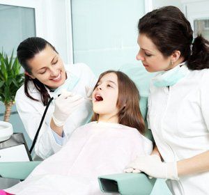 Dentist Examining a Girl's Teeths - Dental Services in Tucson, AZ