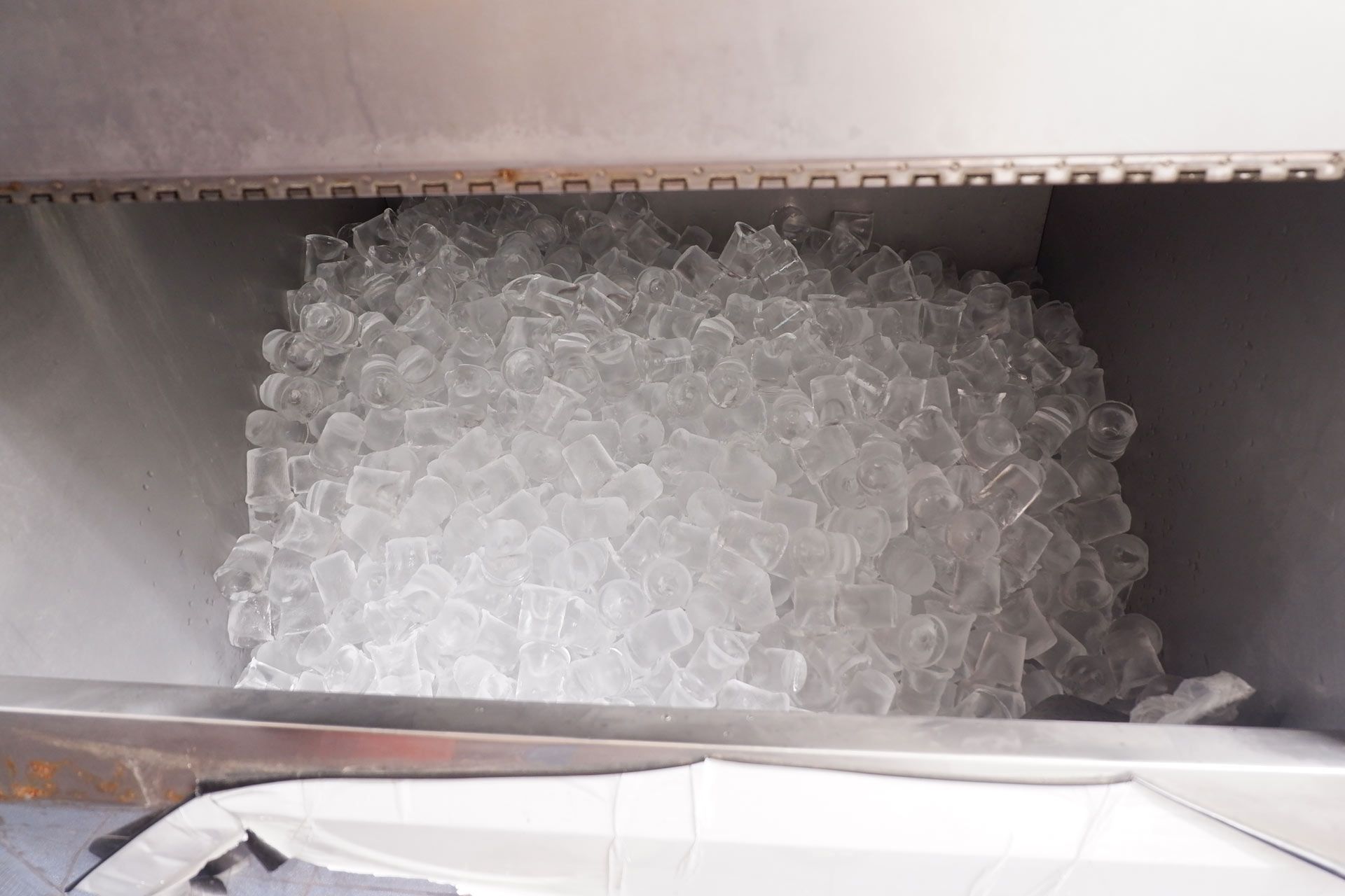 An ice machine filled with cubed ice.
