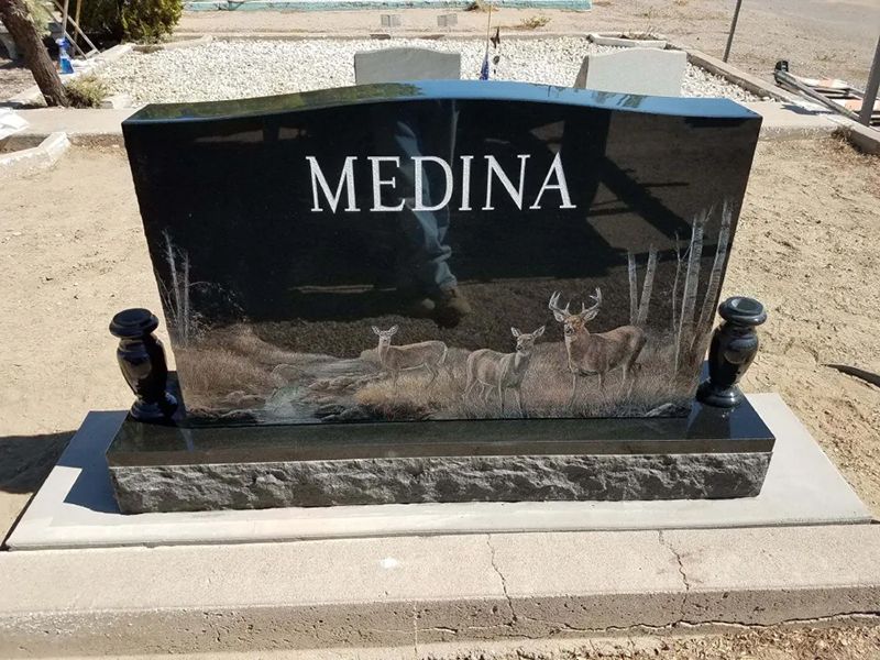Upright headstone with deer carving