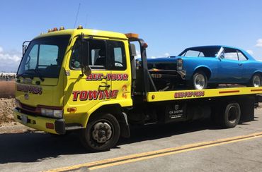 Broken car on tow truck — Hec-Towr Towing in Oxnard, CA