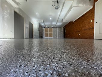 Blue carpeted hallway with white walls and a small open doorway at the far end.