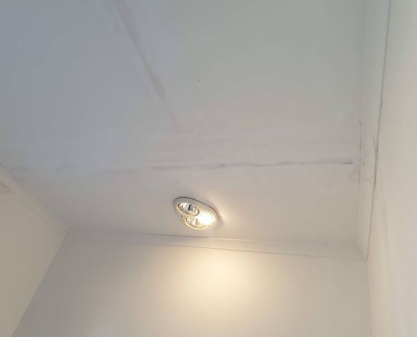 A light is hanging from the ceiling of a room.
