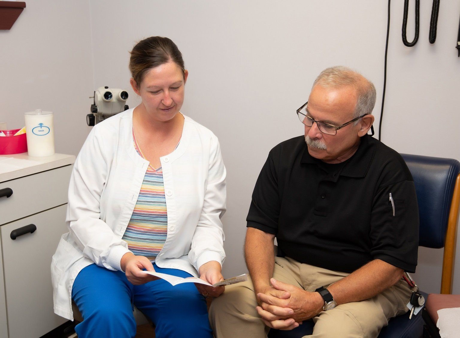 a medical professional giving information to a patient