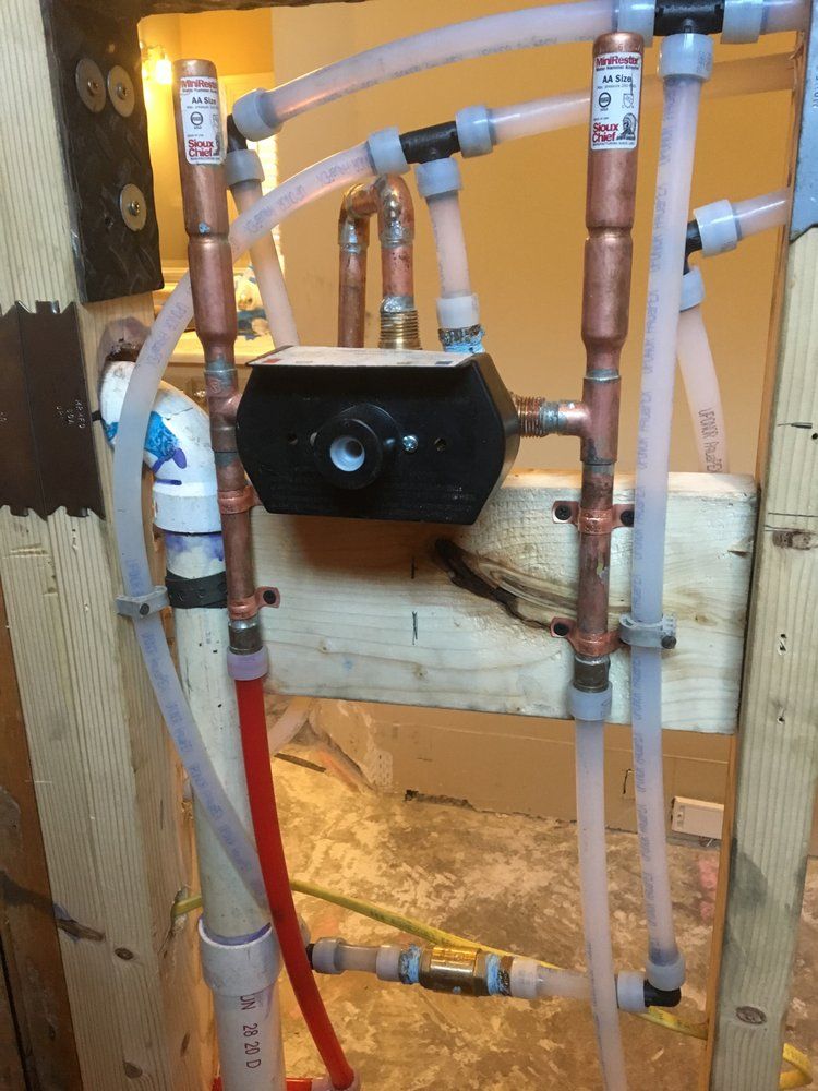 A bunch of pipes are connected to a wall