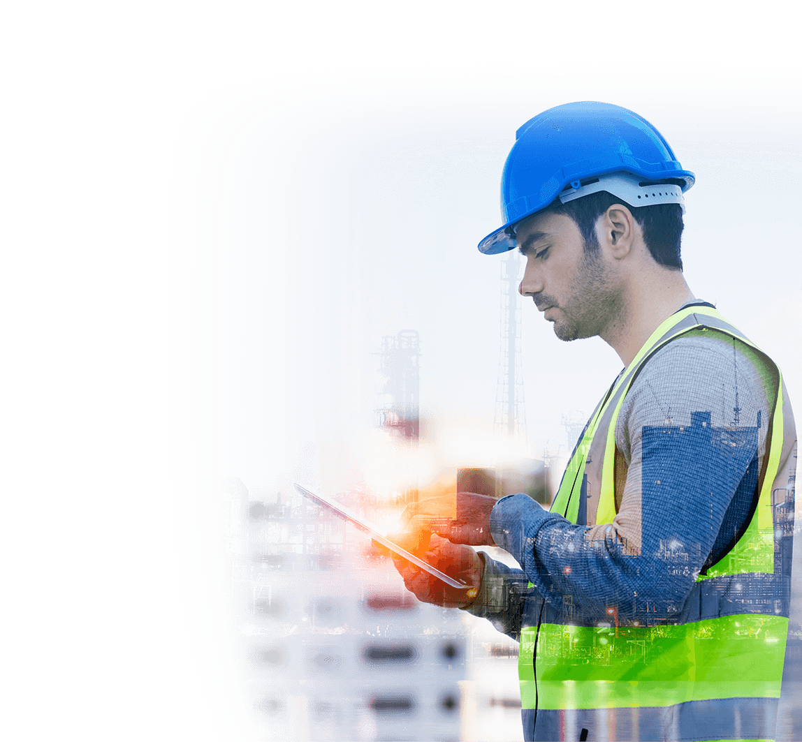 A construction worker wearing a hard hat and safety vest is using a tablet computer.