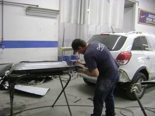 Man Repairing Car Part — Gardiner, ME — Daniel's Auto Body