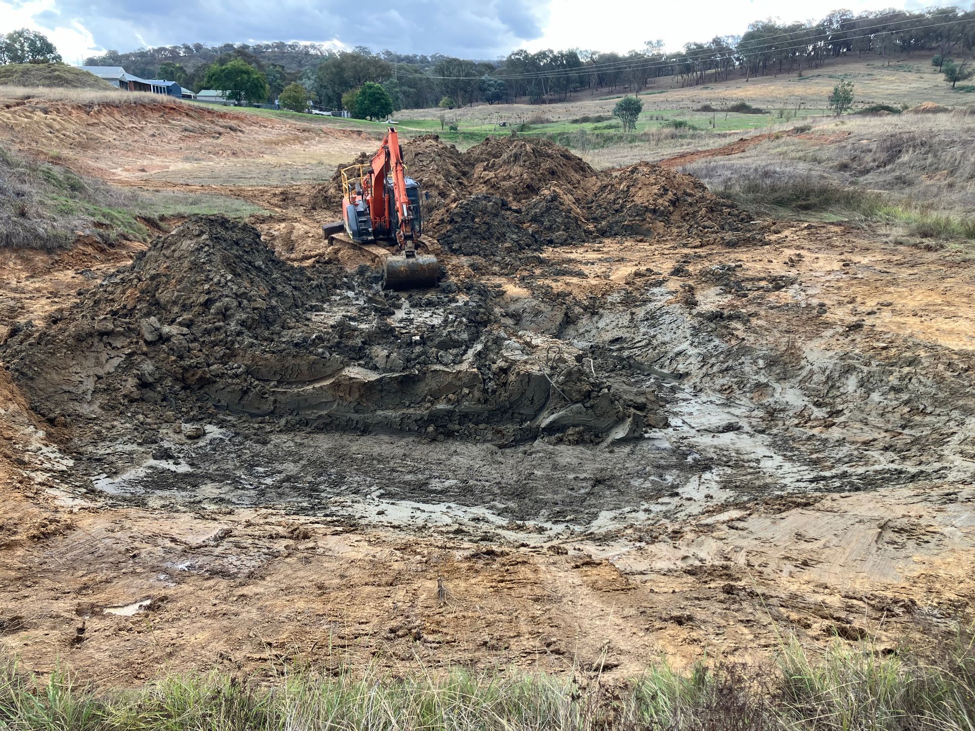 A construction worker is measuring a wall with a tape measure.