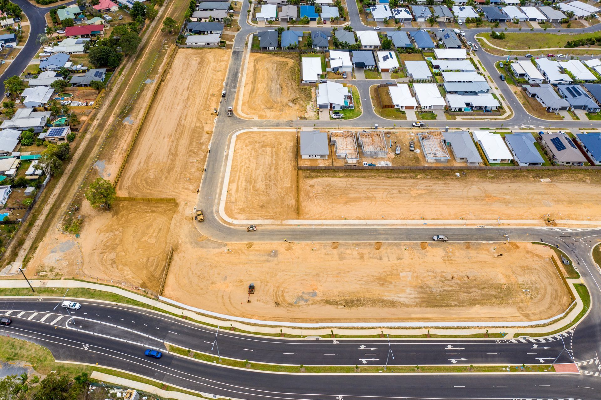 An aerial view of a residential area with lots of houses and roads.