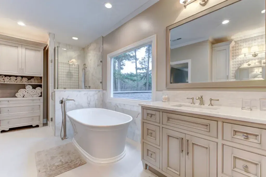 Bright, modern bathroom with a freestanding tub, marble accents, and a large vanity.