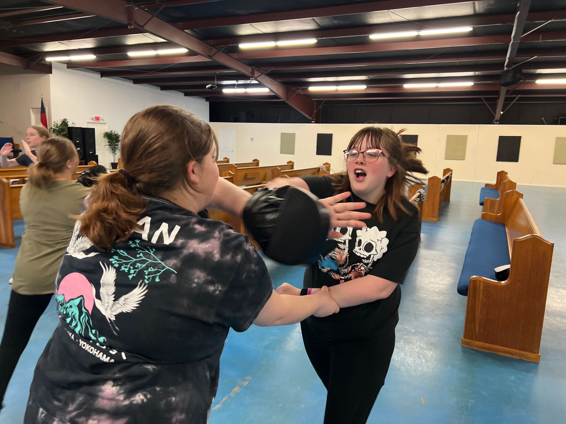 Students practicing practical self-defense drills at Agoge Krav Maga in Lindale, TX to build fitness