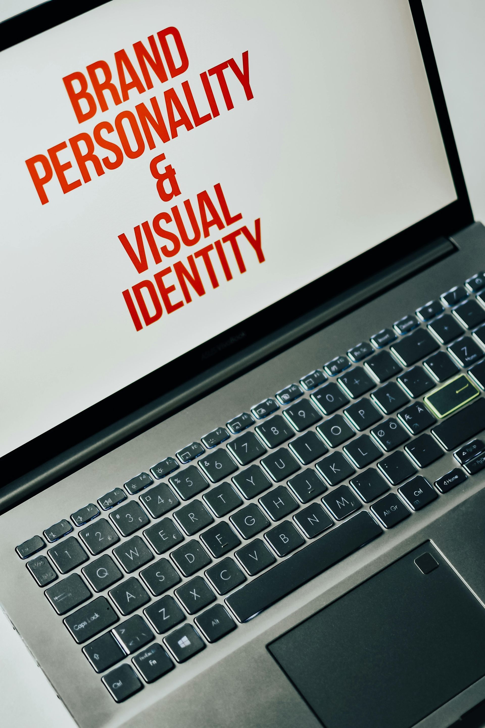 A laptop with a screen that says brand personality and visual identity