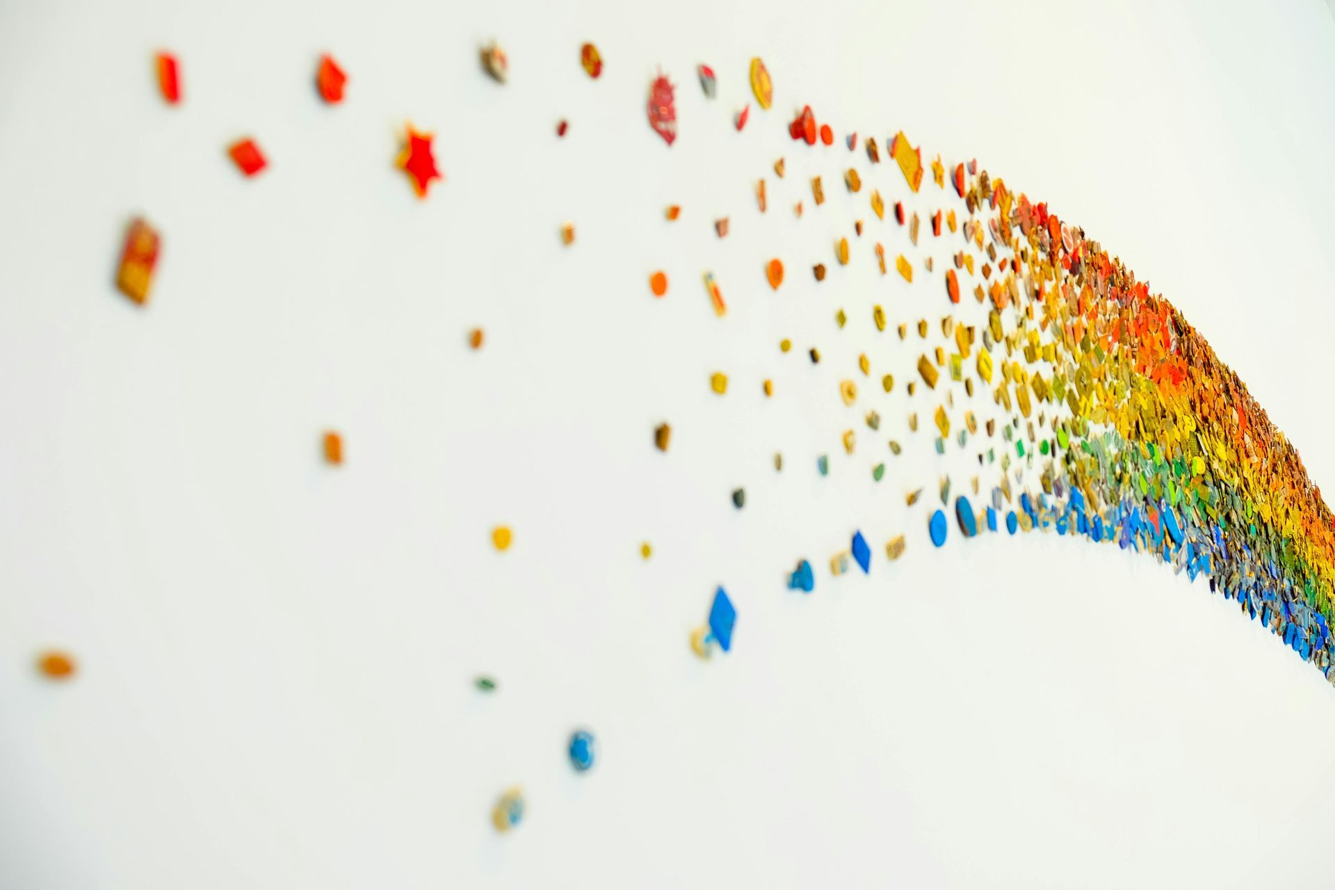 A rainbow made out of crayons on a white background.
