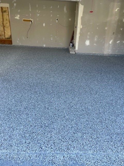 A room with a blue floor and a white wall.