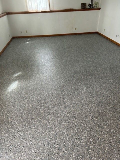 A room with a gray floor and white walls.