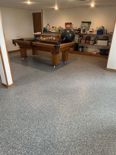 There is a pool table in the middle of the room.