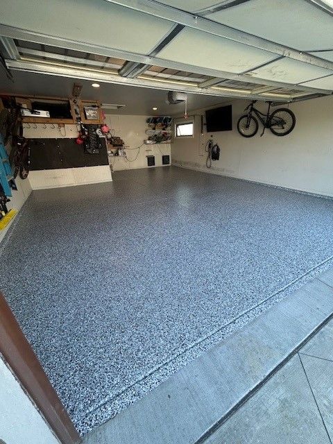 A garage with a bicycle hanging on the wall.