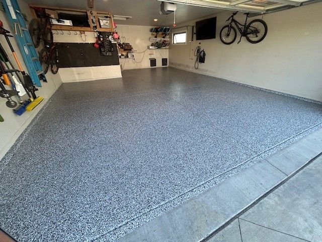 A garage with a bicycle hanging on the wall.