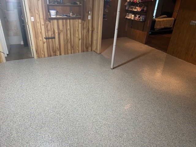 A room with a white floor and a wooden wall.