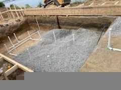 a swimming pool is being built in a hole in the ground .| Virginia Beach, VA | Atlantis Pools