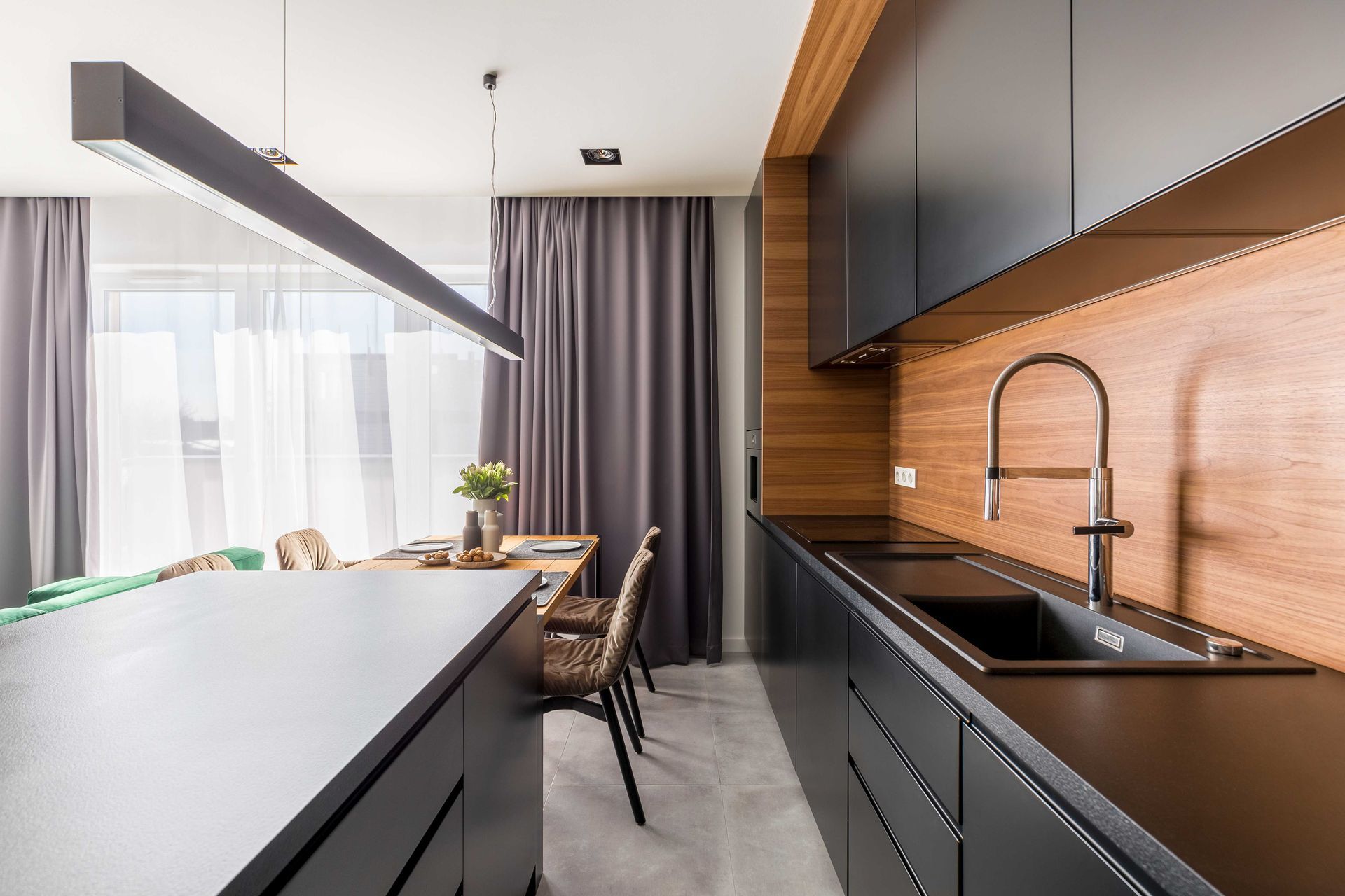 a kitchen with black cabinets and a black sink
