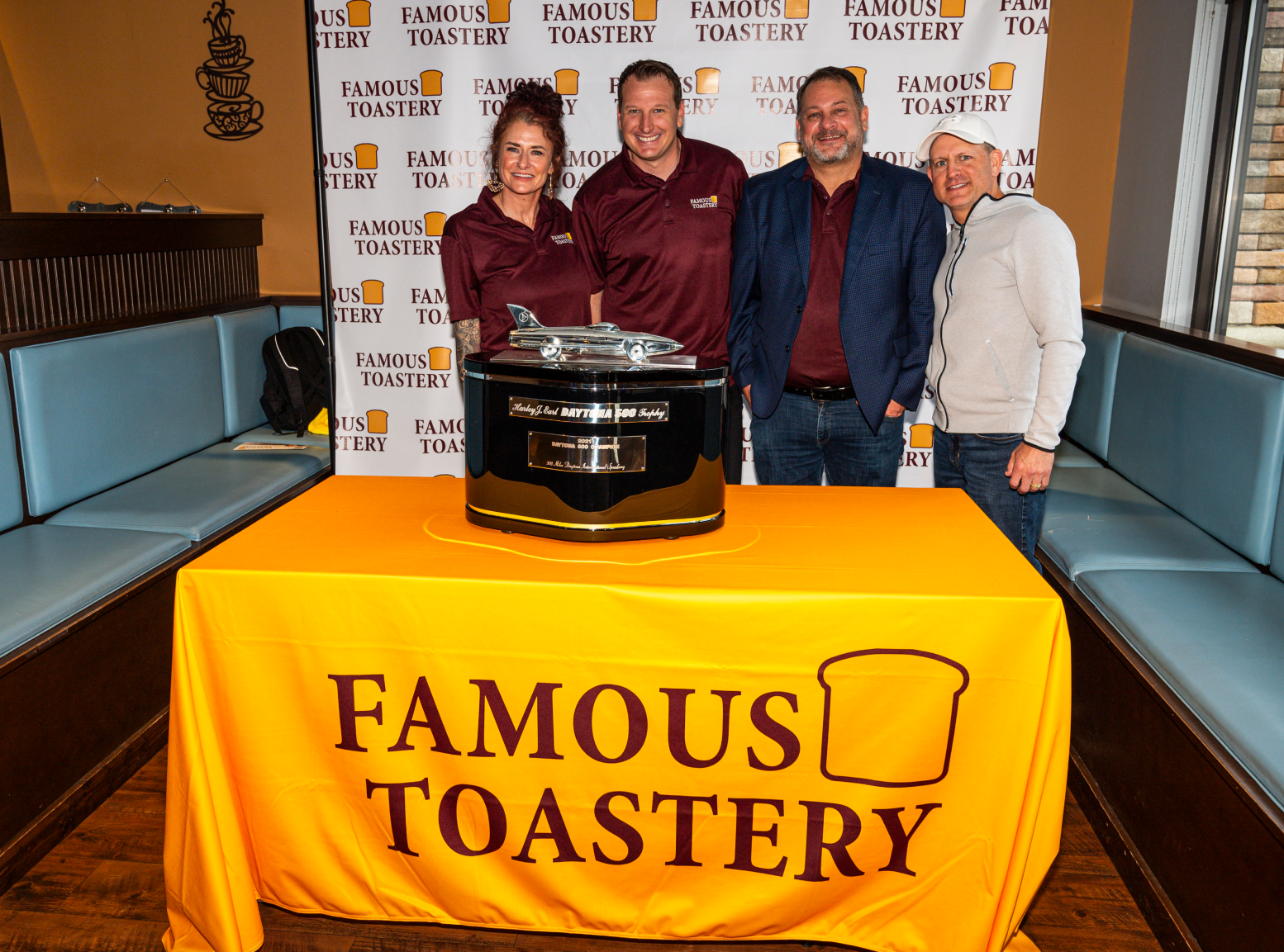 a group of people are posing for a picture in a kitchen .