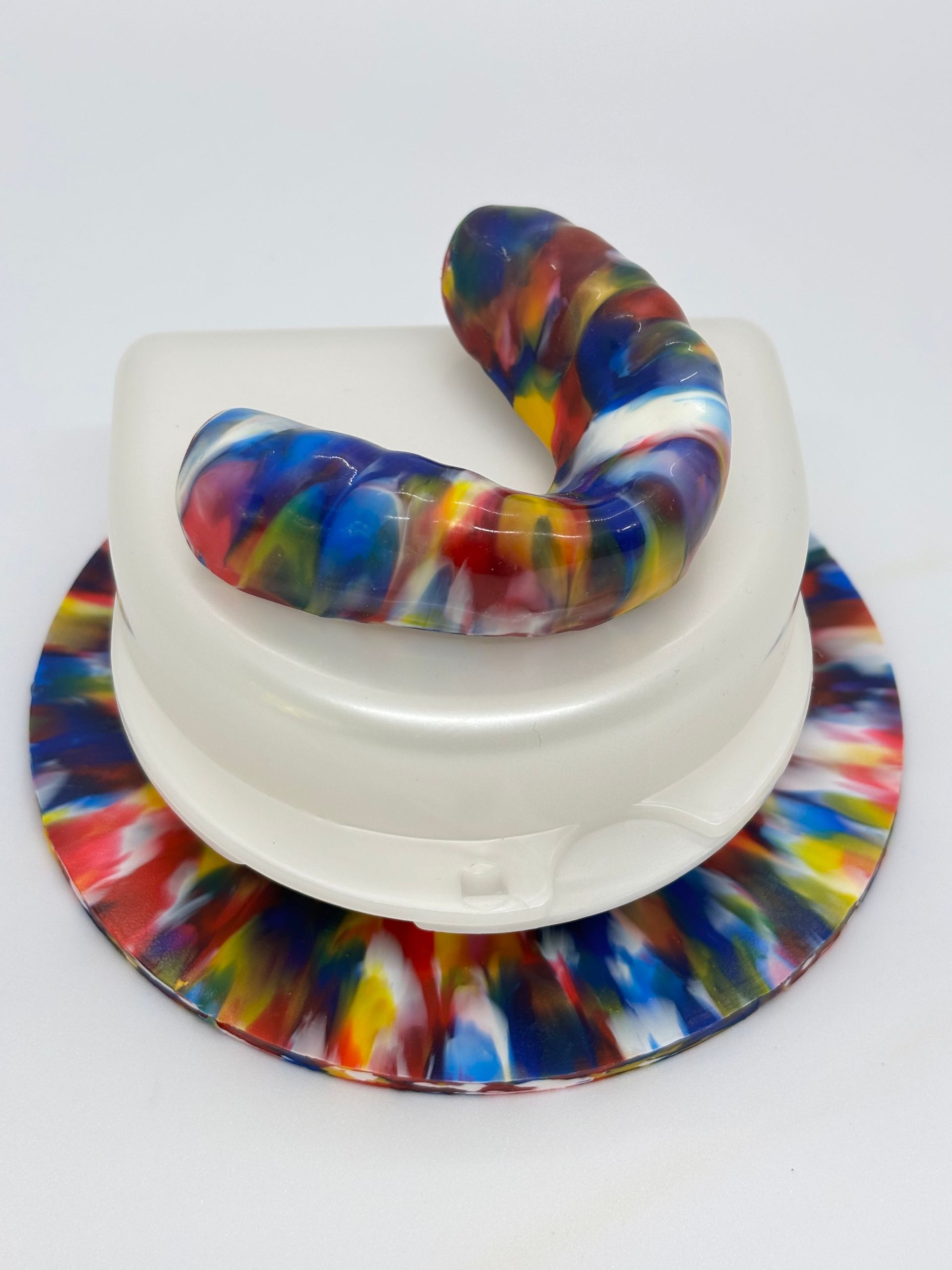 Colorful Abstract Ceramic Sculpture on a White Pedestal With Matching Round Base — Precise Dentures in Berserker, QLD