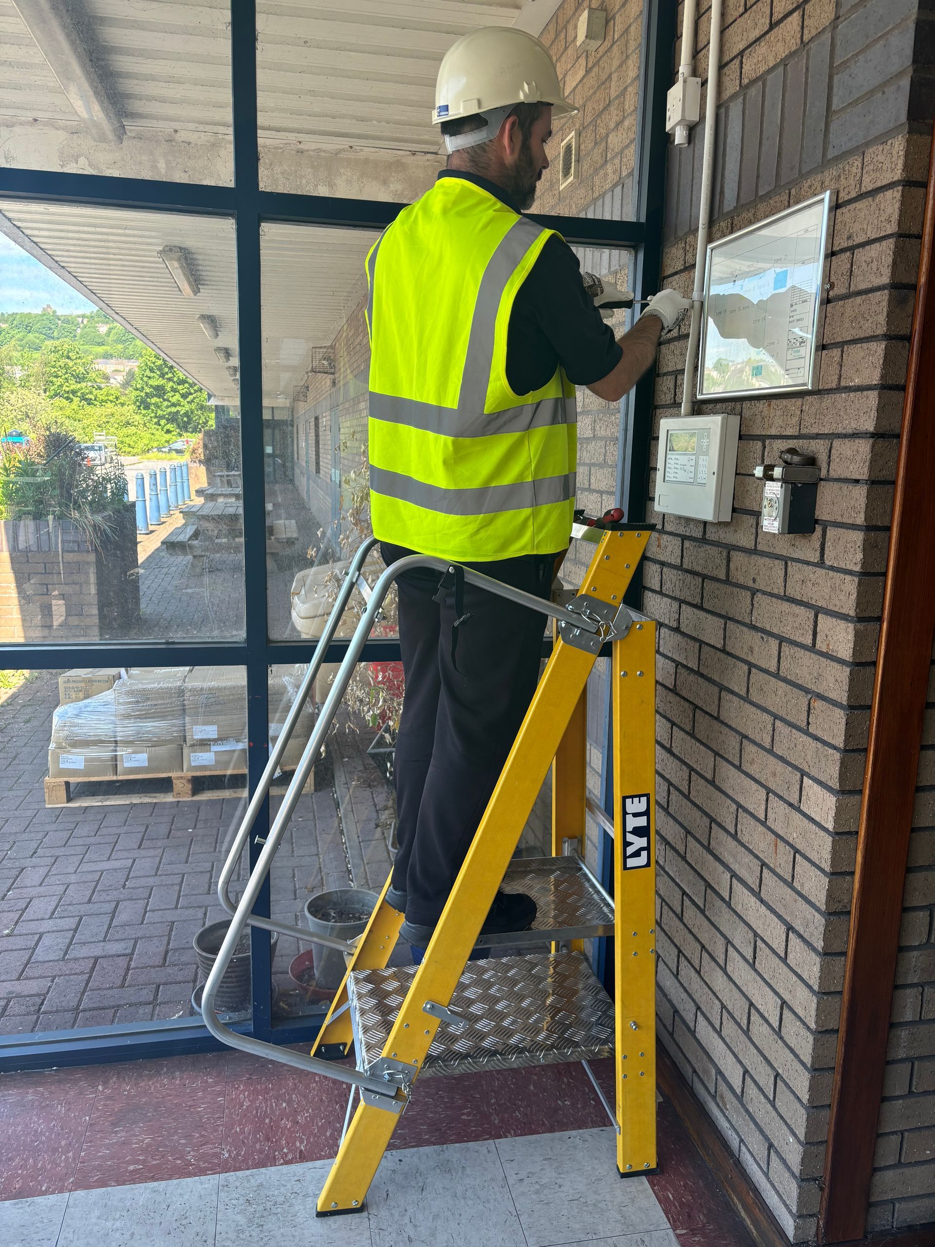 An engineer standing on the upper platform of the dual height Double Decker platform step