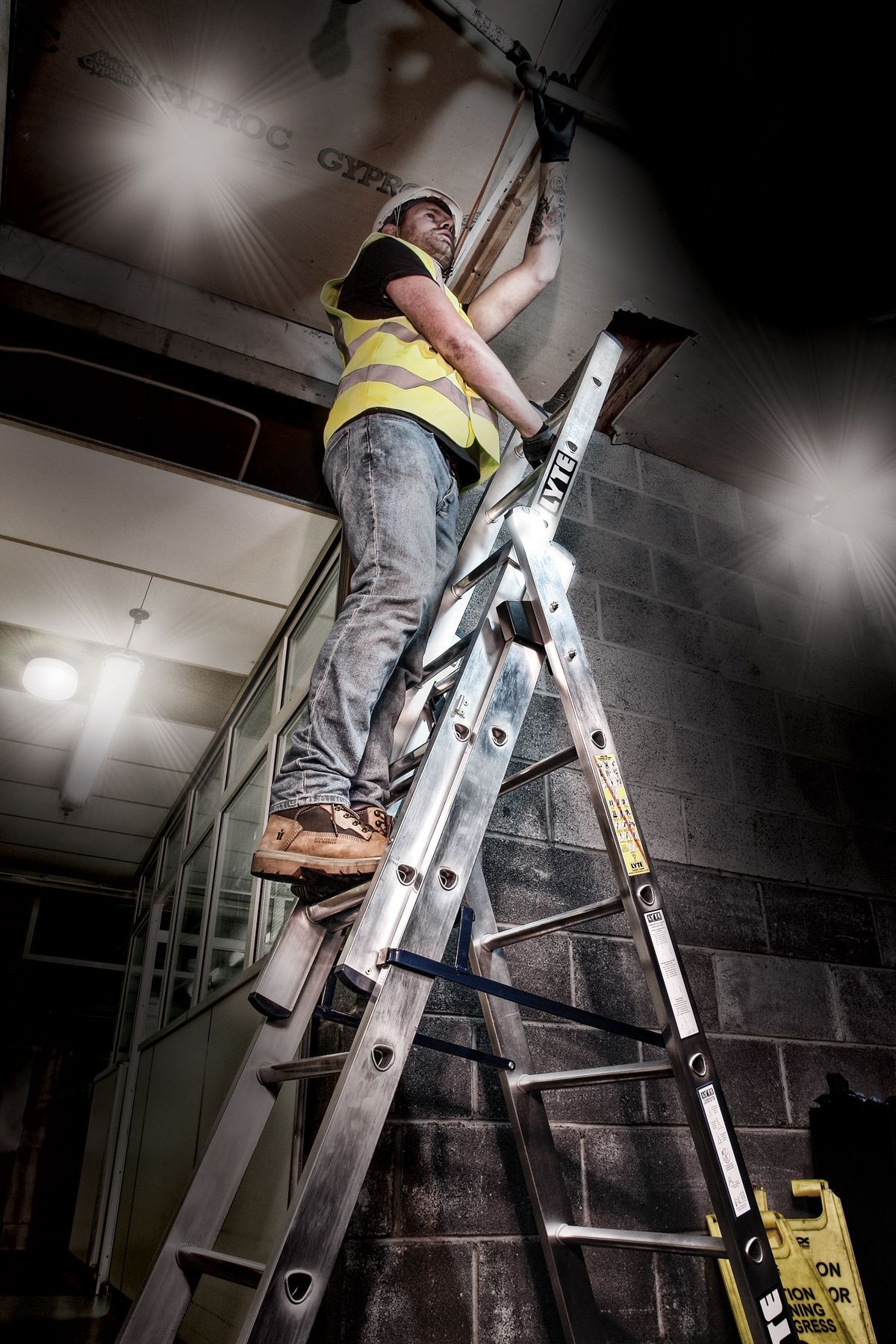 Contractor using a Lyte combination ladder to access ceiling space