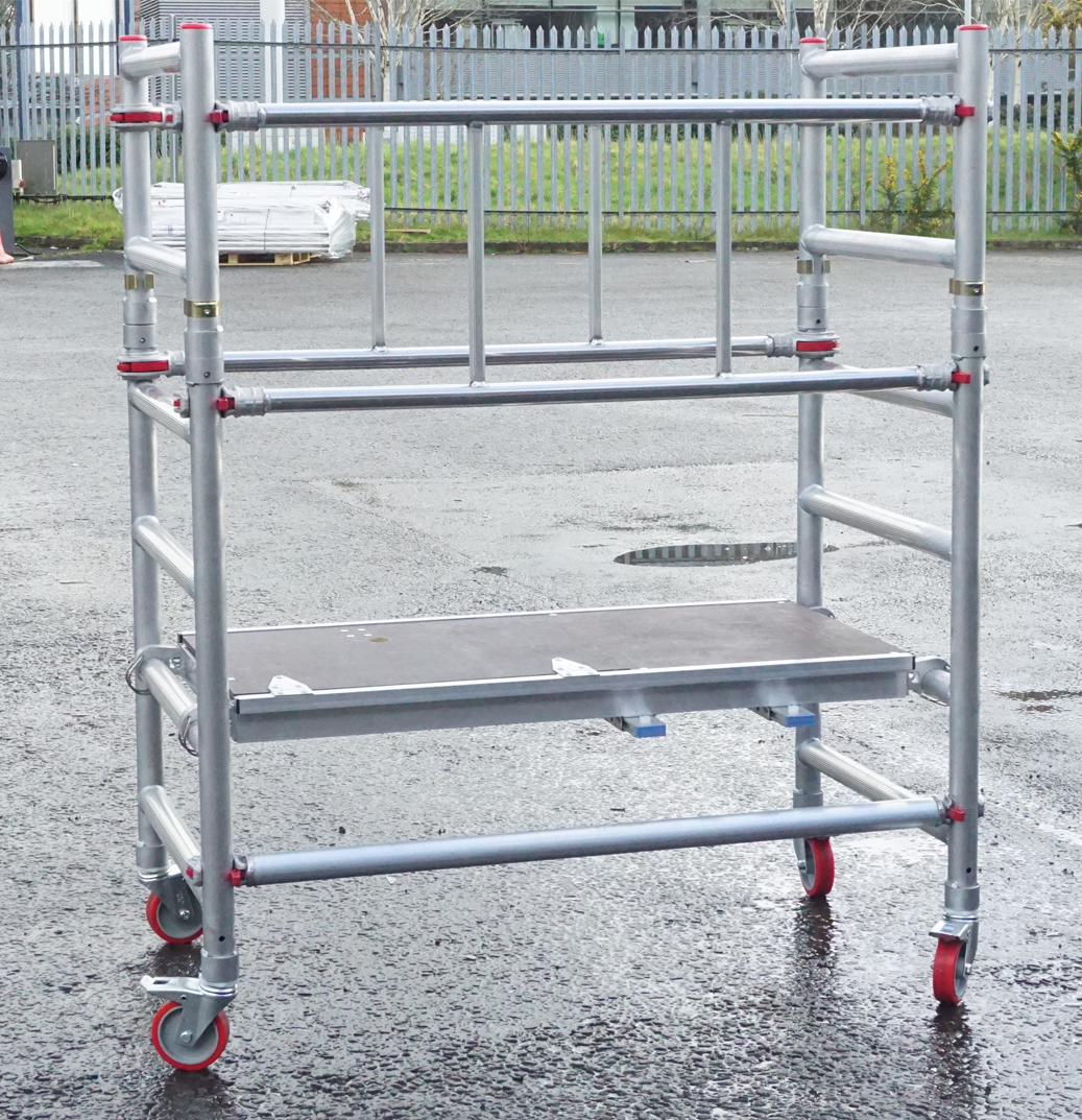 A metal scaffolding with wheels and a wooden platform