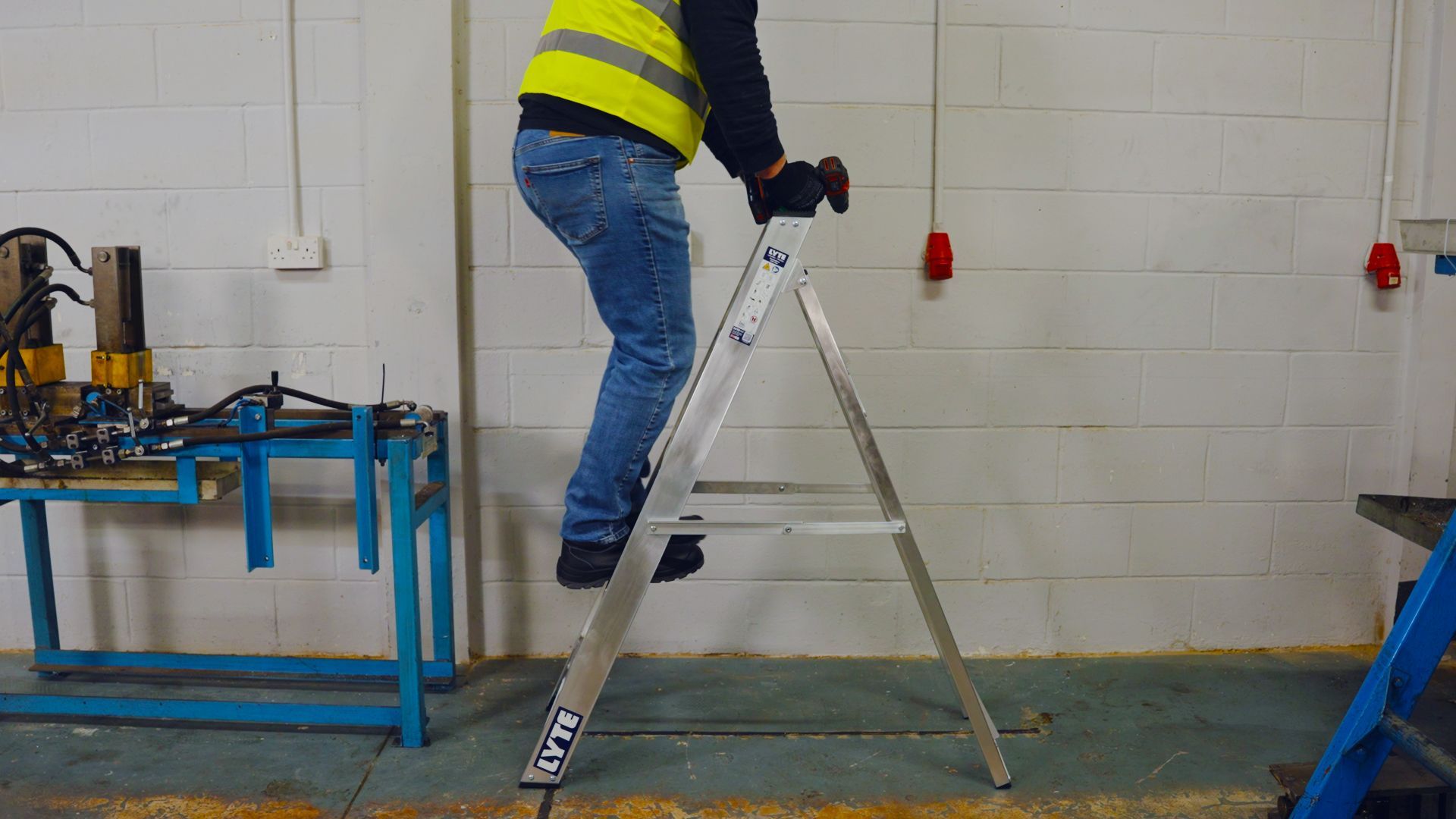 Worker standing on a step ladder