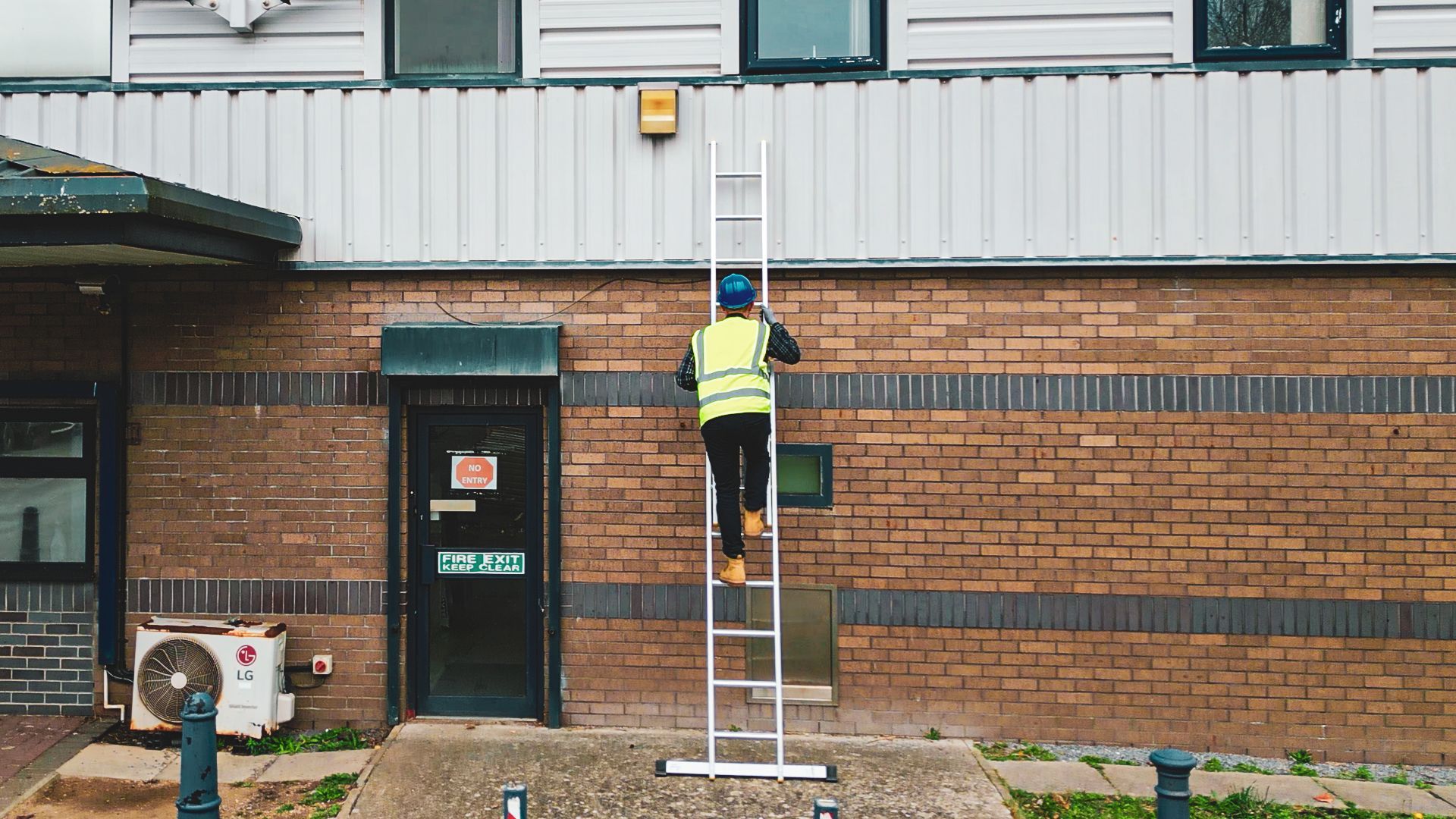 Man climbing a leaning ladder