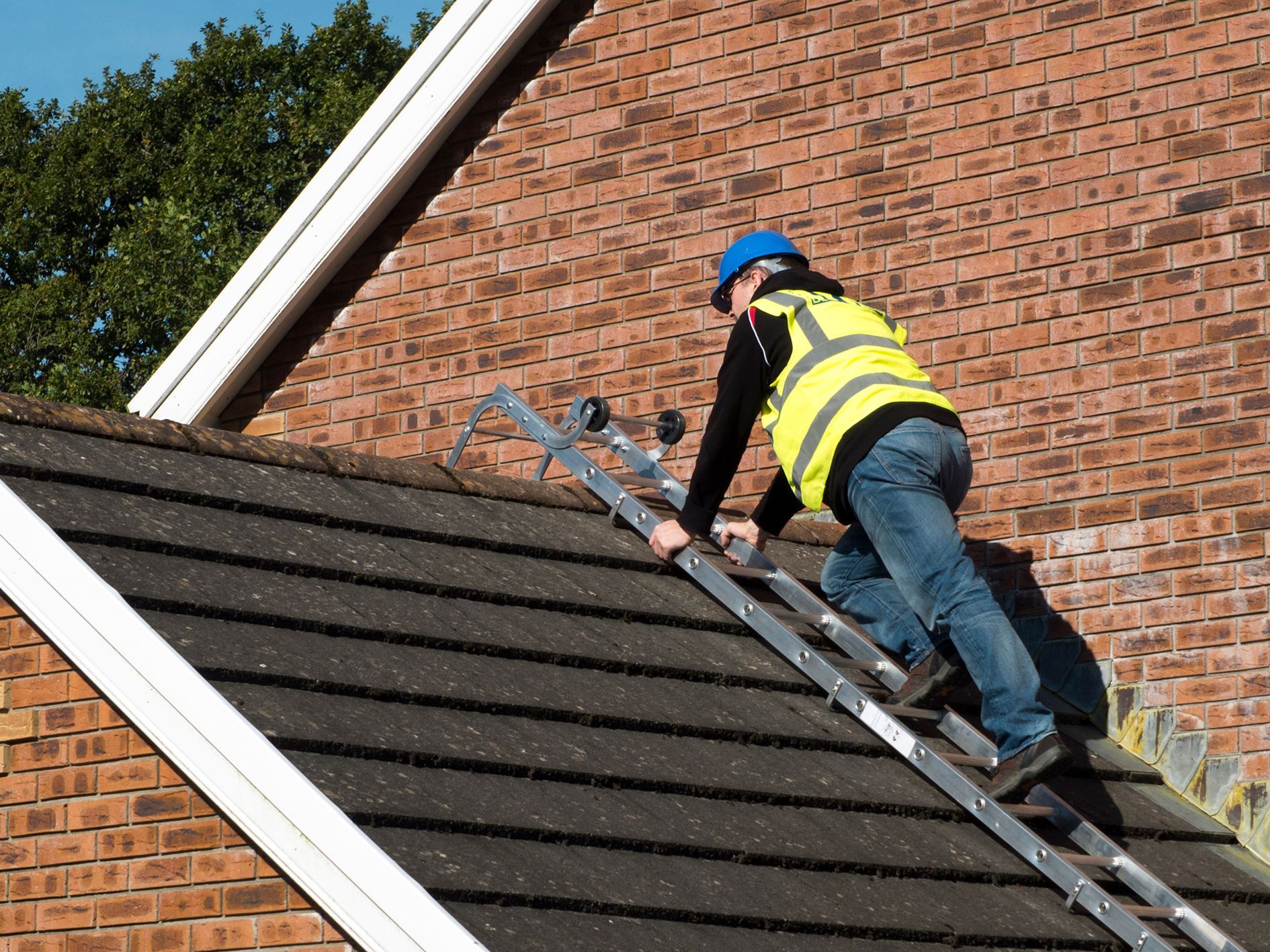 Roofer climbing on a pitched roof with a TRL Trade roof ladder