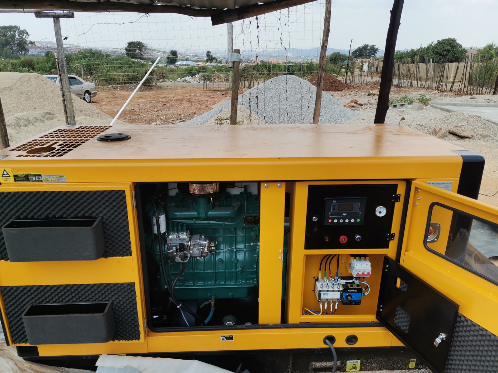 Yellow fuel generator and electrical distribution board connected on building site