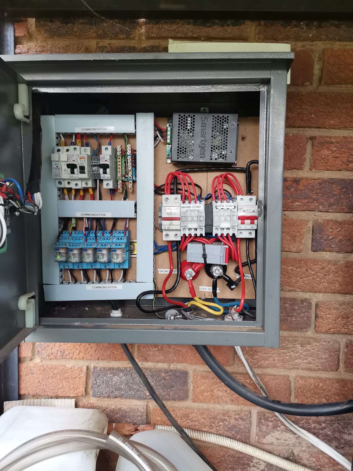 The inside wiring of an electrical distribution board connected to electrical mains and fuel generator