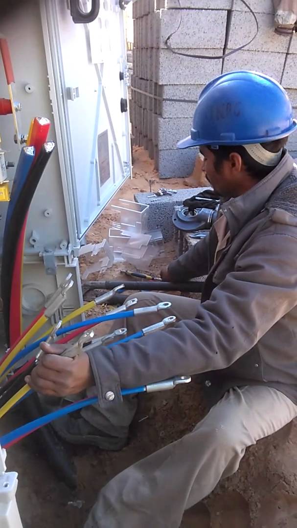 Electrician laying cables for an electrical installation outside