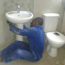 Plumber repairing basin