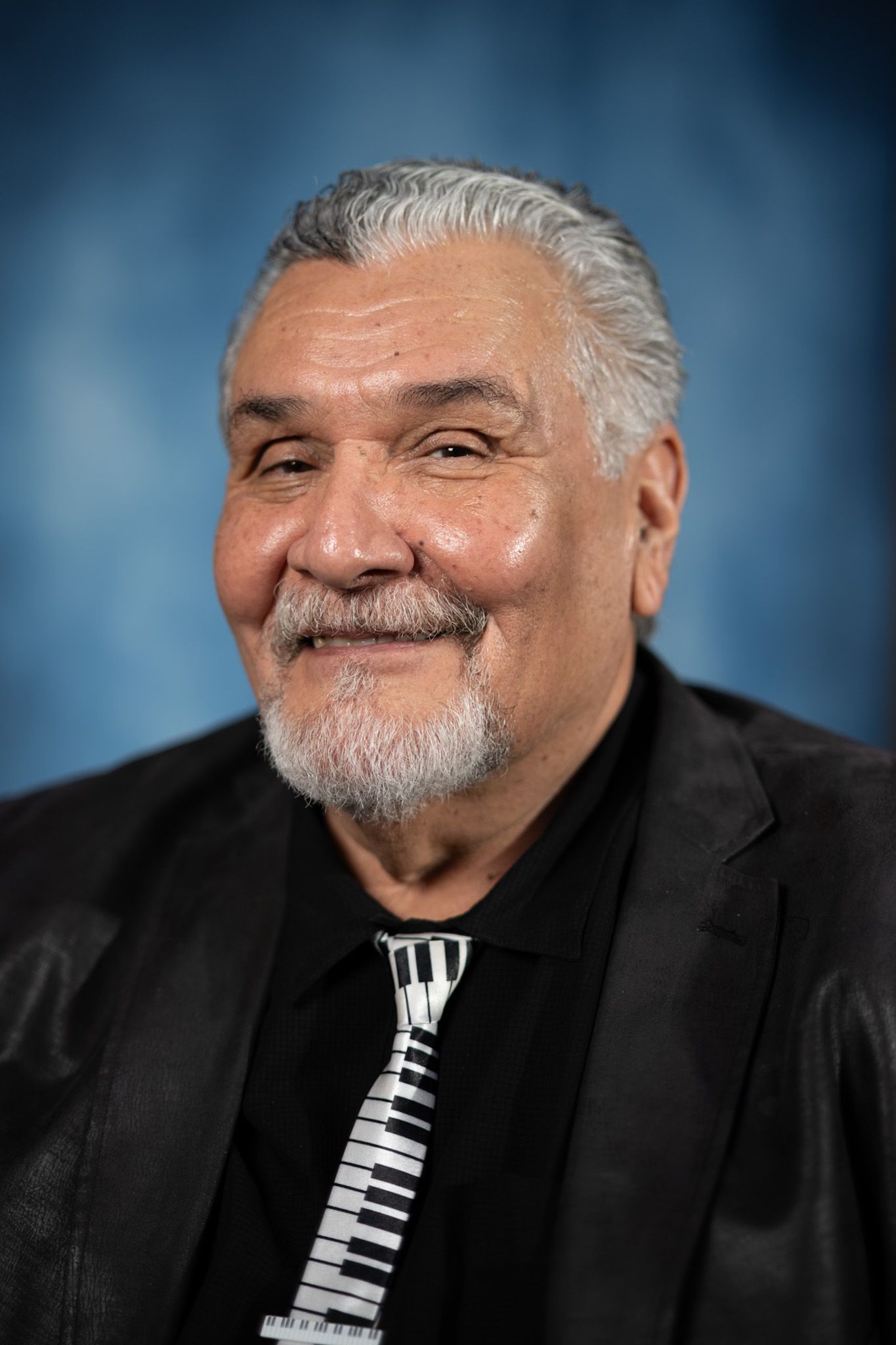 A white deer with antlers is in a circle on a white background.