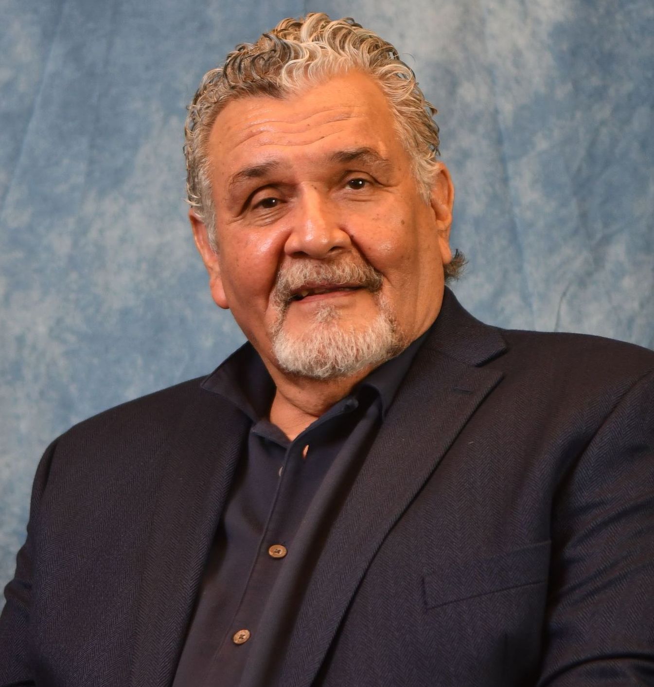 A white deer with antlers is in a circle on a white background.