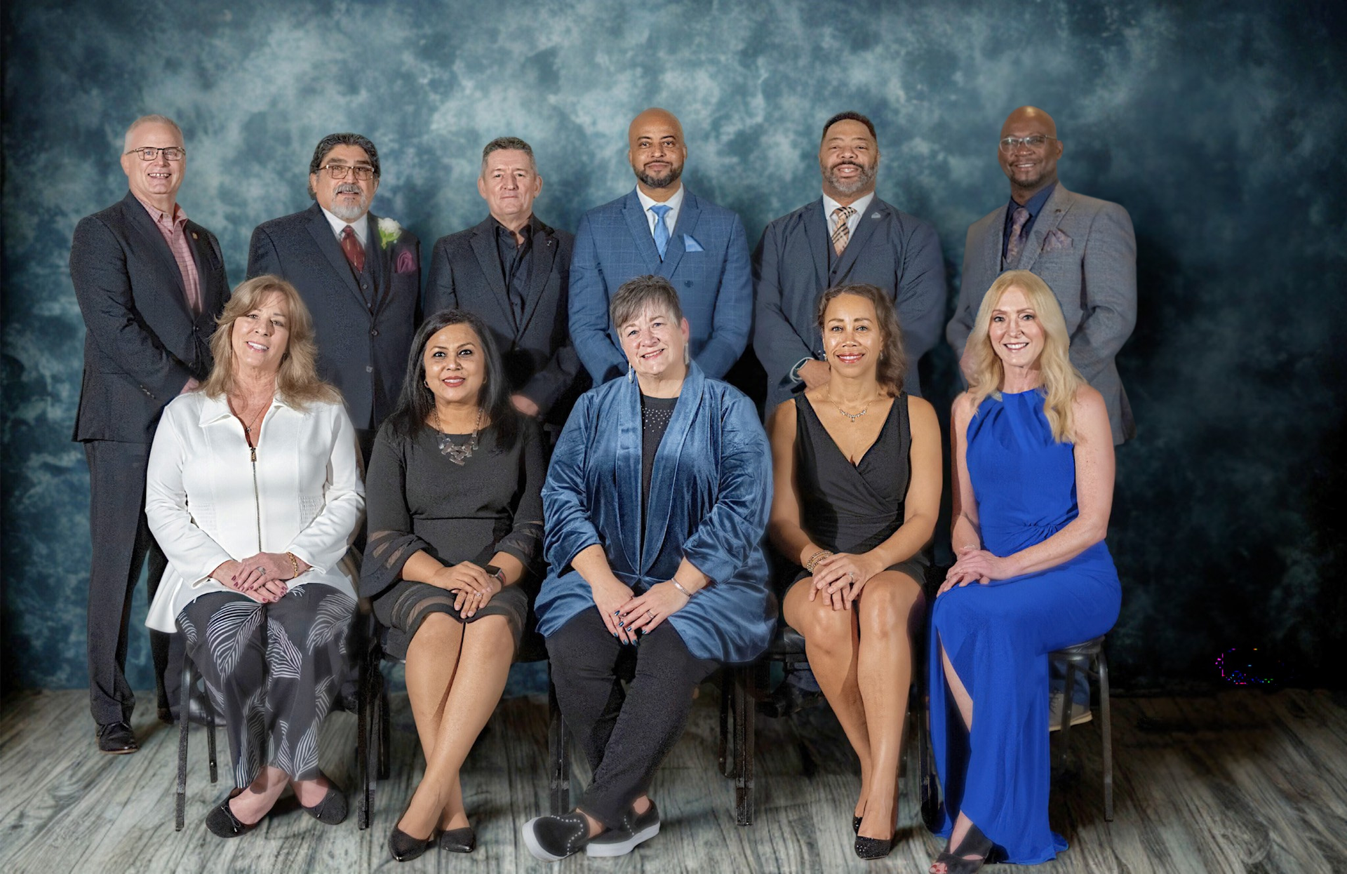A group of people in suits and ties are posing for a picture.