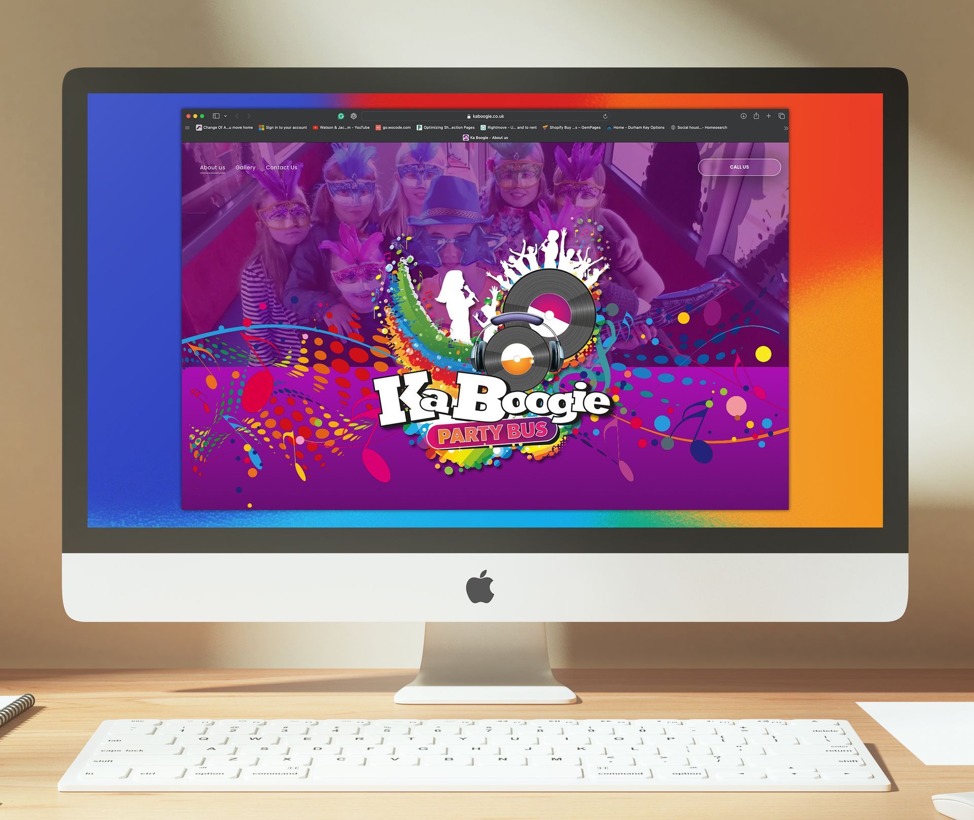 A desktop computer displays the Ka-Boogie Party website with colorful graphics, featuring an album cover image.