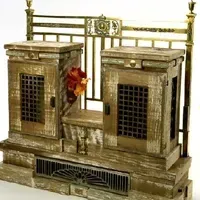 A wooden shelf with two doors and a fence on a white background.