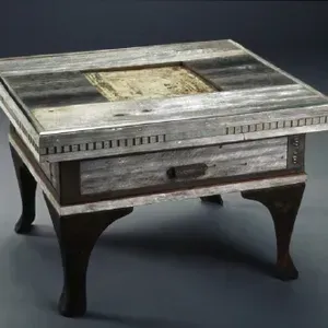A wooden coffee table with a drawer underneath it.