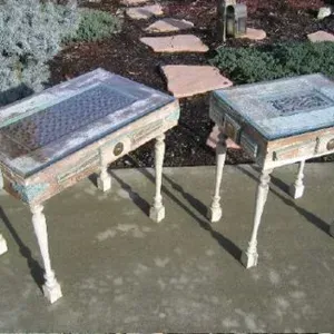 A couple of tables sitting on top of a concrete surface.