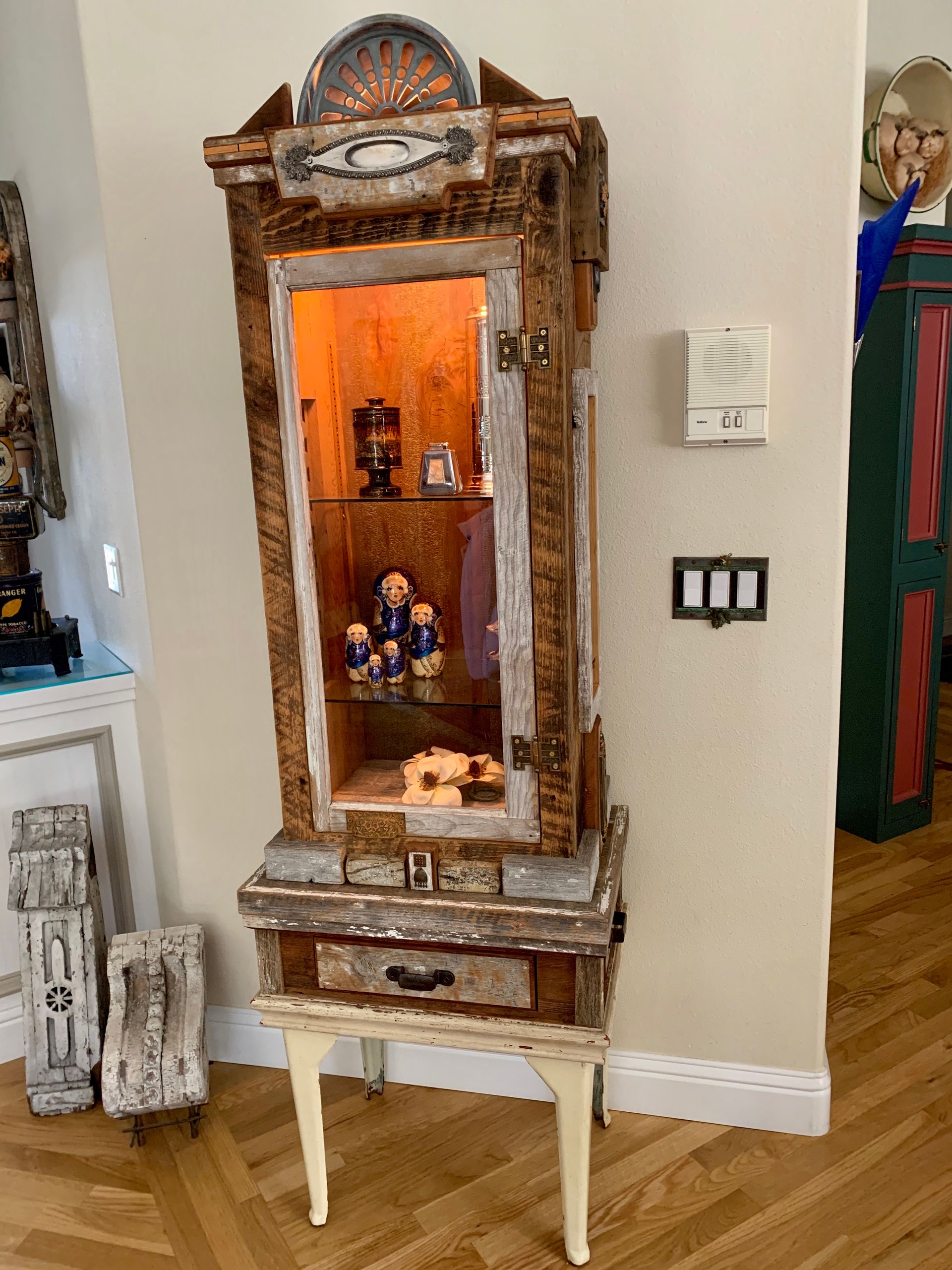 A wooden cabinet with a clock on top of it in a living room.