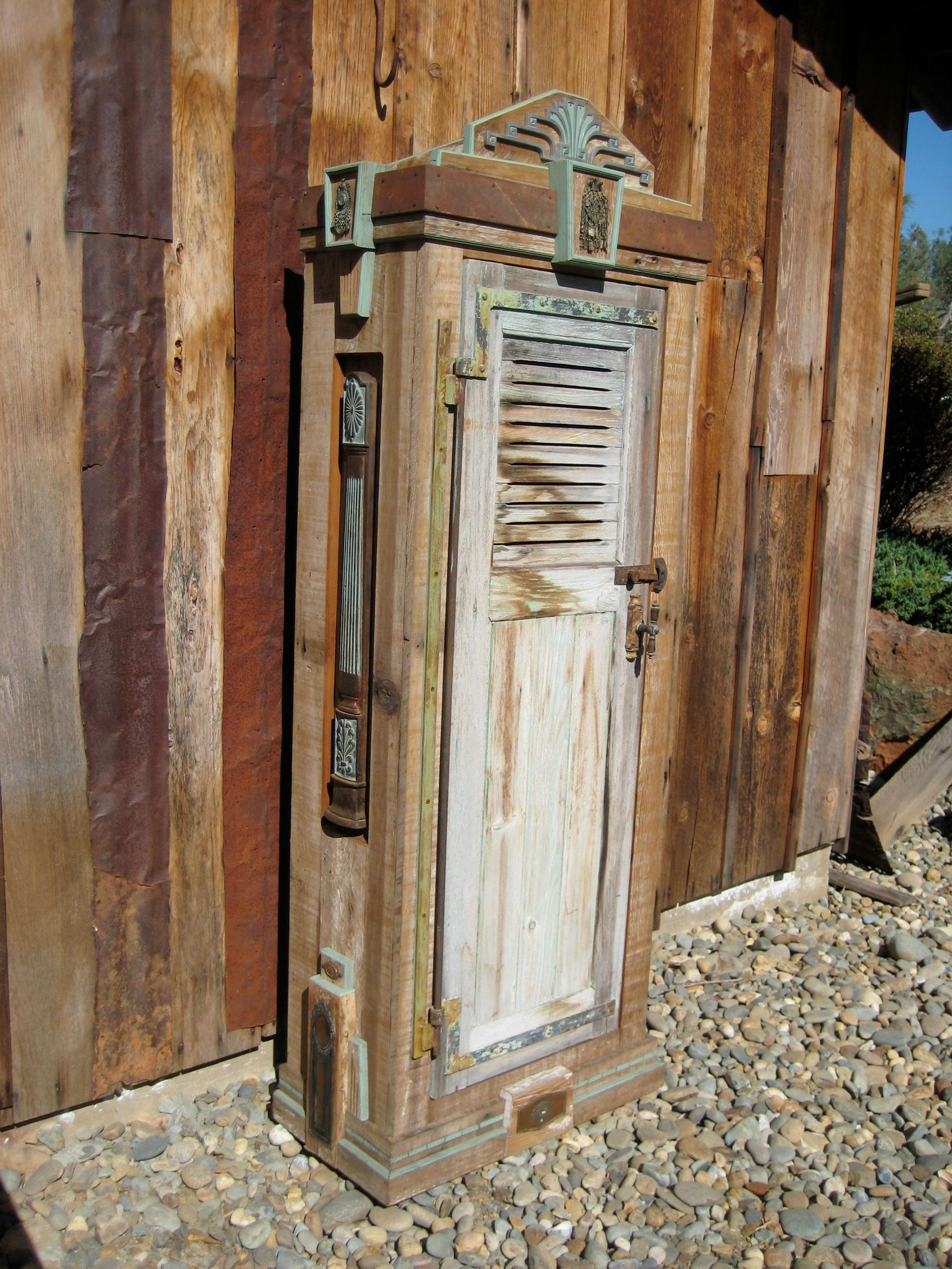 A wooden door with shutters on it is sitting next to a wooden wall.