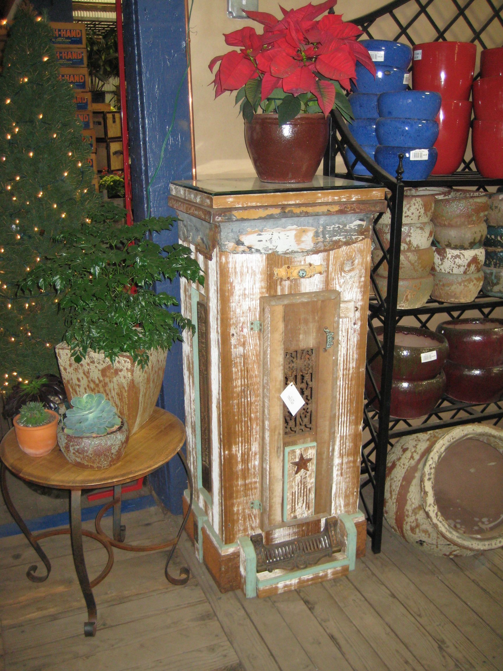 A tent filled with furniture and a painting on the wall.