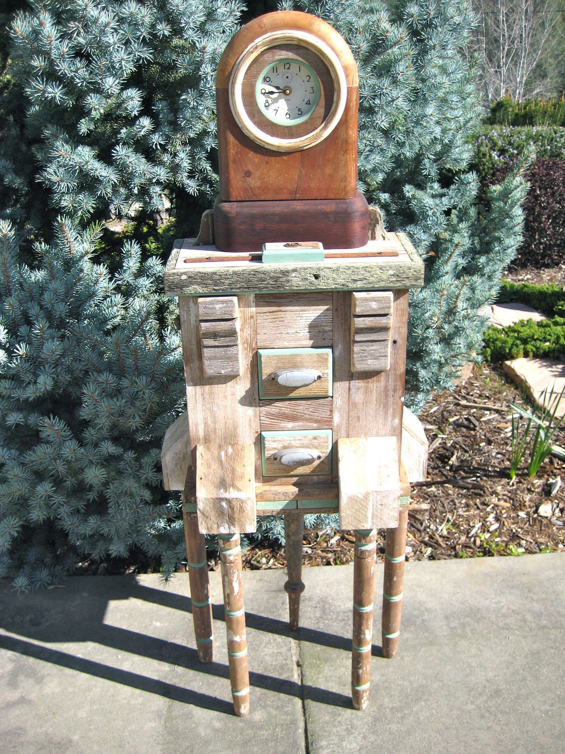 A wooden clock sitting on top of a wooden table.