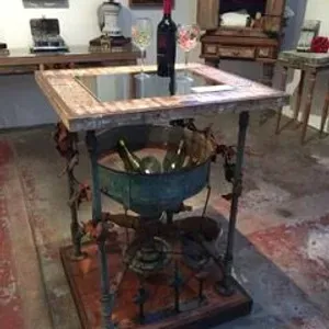 A table with bottles of wine and glasses on it.