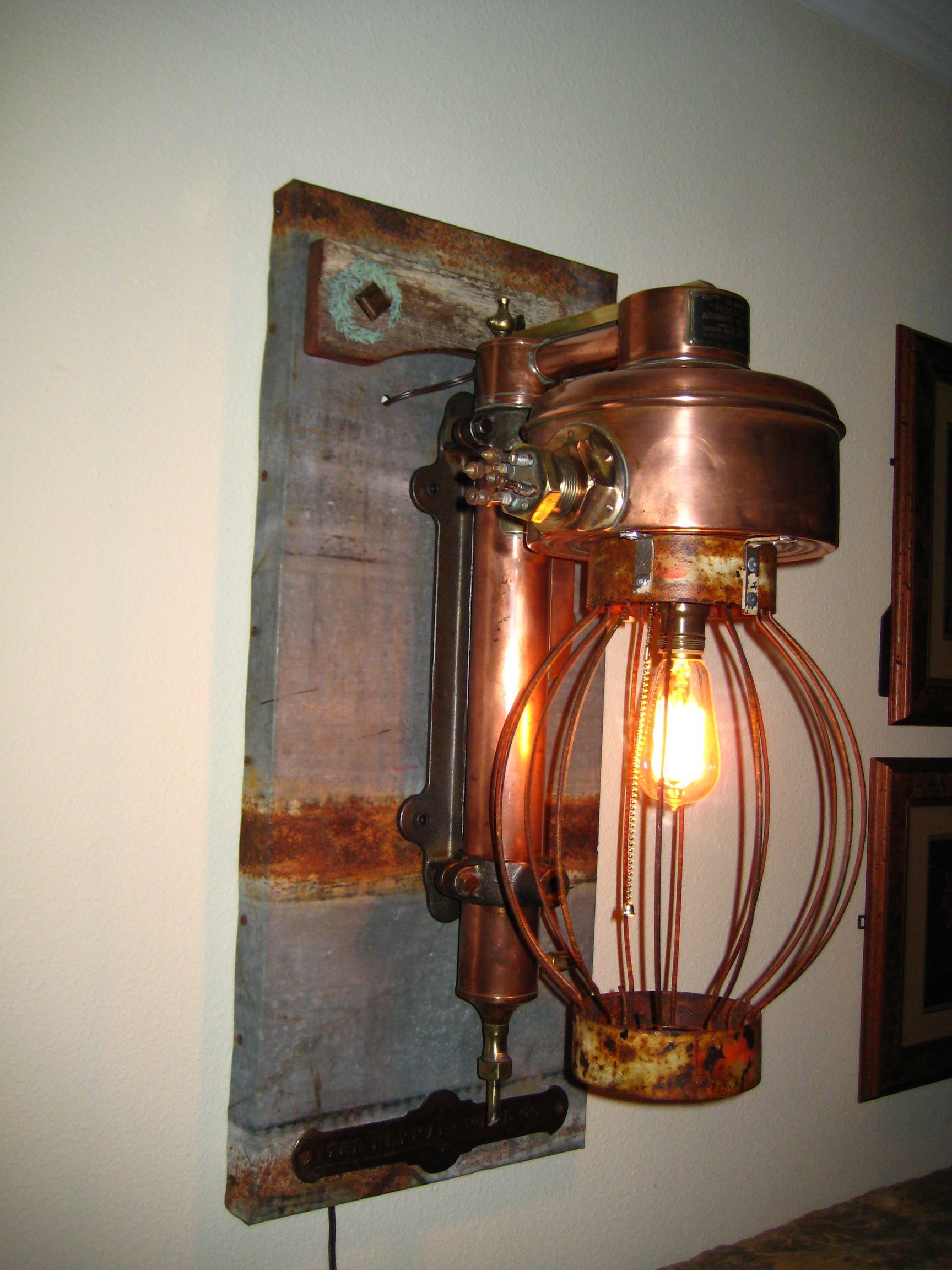 A copper wall light with a light bulb is hanging on a wall.